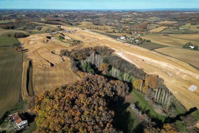 This aerial view, taken on December 8, 2025 in Saix, shows an area of illegal encroachment on the A69 motorway construction site. The prefects of Haute-Garonne and Tarn say they have noted overruns in the construction area of the A69 motorway, as denounced by opponents of the project, and are demanding explanations from the concessionaire, according to a statement released on December 2, 2025. (Photo by Lionel BONAVENTURE / AFP)