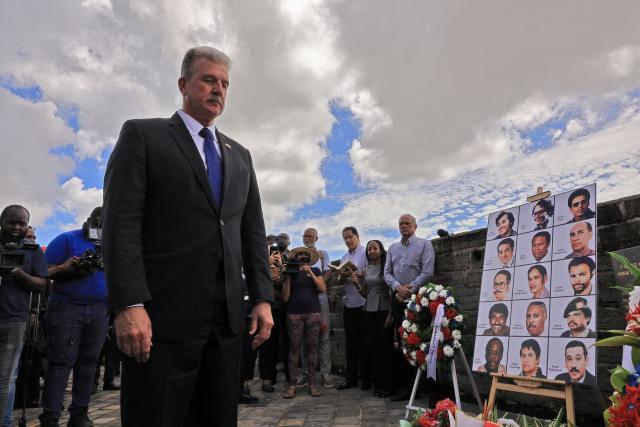US Ambassador to Suriname Robert Faucher attends the 43 anniversary of the December murders, when 15 victims were executed, at the former Fort Zeelandia military barracks in Paramaribo on December 8, 2025. Relatives of the 15 victims killed filed a lawsuit against the government demanding rehabilitation and compensation. (Photo by Ranu ABHELAKH / AFP)