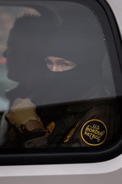 A US Customs and Border Patrol agent sits in a vehicle during operations in Kenner, Louisiana, on December 8, 2025. The US Department of Homeland Security announced on December 3 it has launched a federal immigration enforcement operation, named "Operation Catahoula Crunch," in the New Orleans, Louisiana area. (Photo by Adam GRAY / AFP)