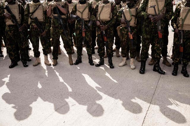 Kenyan police officers arrive at Toussaint Louverture International Airport in Port-au-Prince, Haiti, on December 8, 2025. Kenya announced on December 8th that it had deployed more than 230 highly specialized police officers. They arrive at a critical moment, following the expansion of the Gang Suppression Force's (GSF) mandate published on October 3, 2025. (Photo by Clarens SIFFROY / AFP)