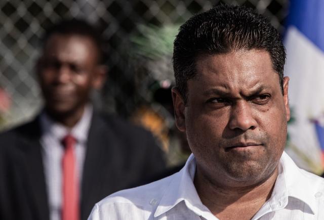 President of Haiti’s Transitional Presidential Council, Laurent Saint-Cyr speaks during the arrival of the Kenyan police officers at Toussaint Louverture International Airport in Port-au-Prince, Haiti, on December 8, 2025. Kenya announced on December 8th that it had deployed more than 230 highly specialized police officers. They arrive at a critical moment, following the expansion of the Gang Suppression Force's (GSF) mandate published on October 3, 2025. (Photo by Clarens SIFFROY / AFP)