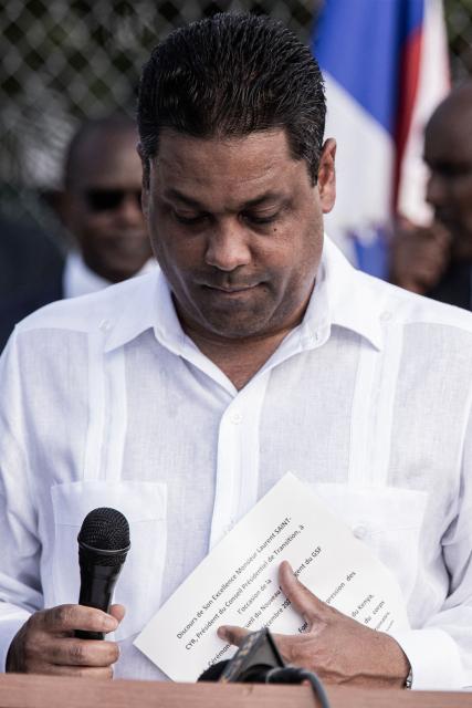 President of Haiti’s Transitional Presidential Council, Laurent Saint-Cyr speaks during the arrival of the Kenyan police officers at Toussaint Louverture International Airport in Port-au-Prince, Haiti, on December 8, 2025. Kenya announced on December 8th that it had deployed more than 230 highly specialized police officers. They arrive at a critical moment, following the expansion of the Gang Suppression Force's (GSF) mandate published on October 3, 2025. (Photo by Clarens SIFFROY / AFP)