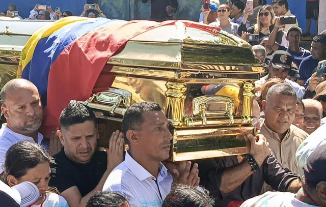 Supporters of Alfredo Diaz, an opposition leader who died in prison, carry his coffin during his funeral in Isla Margarita, Venezuela on December 8, 2025. Venezuela acknowledged on December 8, 2025, that Diaz, an opposition figure, died while in custody, as the Trump administration slammed Caracas as "vile" and the South American country's army swore in thousands of new soldiers amid mounting US military pressure. (Photo by Giam León / AFP)