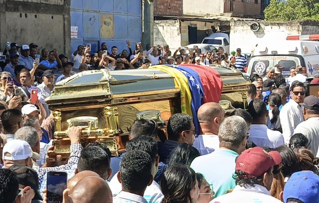 Supporters of Alfredo Diaz, an opposition leader who died in prison, carry his coffin during his funeral in Isla Margarita, Venezuela on December 8, 2025. Venezuela acknowledged on December 8, 2025, that Diaz, an opposition figure, died while in custody, as the Trump administration slammed Caracas as "vile" and the South American country's army swore in thousands of new soldiers amid mounting US military pressure. (Photo by Giam León / AFP)