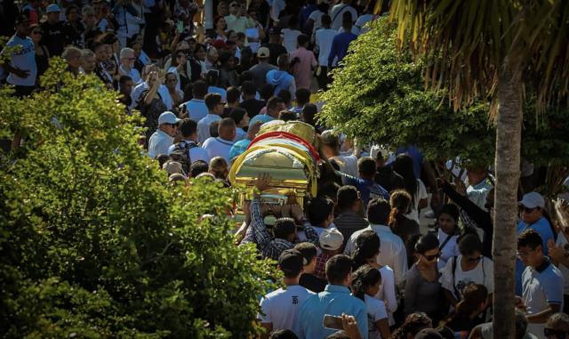 Supporters of Alfredo Diaz, an opposition leader who died in prison, carry his coffin during his funeral in Isla Margarita, Venezuela on December 8, 2025. Venezuela acknowledged on December 8, 2025, that Diaz, an opposition figure, died while in custody, as the Trump administration slammed Caracas as "vile" and the South American country's army swore in thousands of new soldiers amid mounting US military pressure. (Photo by Giam León / AFP)