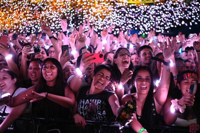 Fan of Colombian singer Shakira sign her songs as they attend her "Las mujeres ya no lloran" world tour at Velez Sarsfield stadium in Buenos Aires on December 8, 2025. (Photo by Luis ROBAYO / AFP)