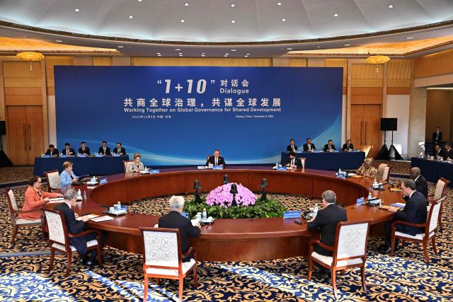 China’s Premier Li Qiang (C) attends the 1+10 Dialogue with leaders of International Economic Organisations in Beijing on December 9, 2025. (Photo by Pedro PARDO / POOL / AFP)
