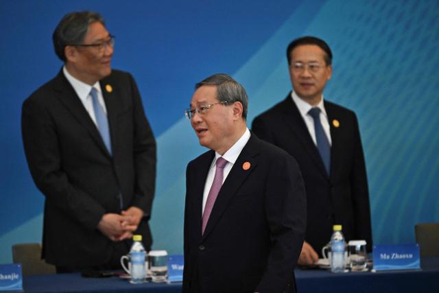 China’s Premier Li Qiang (C) attends the 1+10 Dialogue with leaders of International Economic Organisations in Beijing on December 9, 2025. (Photo by Pedro PARDO / POOL / AFP)