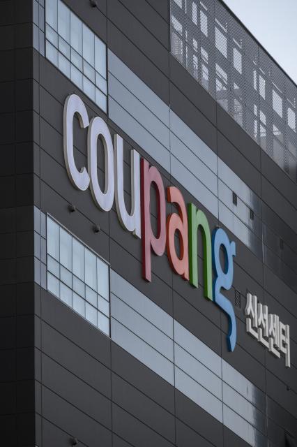 (FILES) A general view shows the logo of South Korean online delivery service Coupang, at the company's warehouse in Bucheon, south of Seoul on May 27, 2020. South Korean police raided on December 9, 2025, the headquarters of e-commerce giant Coupang over a recent data leak believed to have affected more than 33 million customers. (Photo by Ed JONES / AFP)