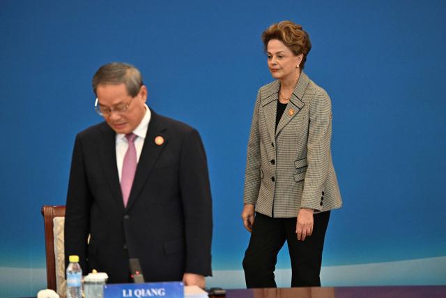 China’s Premier Li Qiang (L) and President of the New Development Bank (NDB) Dilma Rousseff attend the 1+10 Dialogue with leaders of International Economic Organisations in Beijing on December 9, 2025. (Photo by Pedro PARDO / POOL / AFP)
