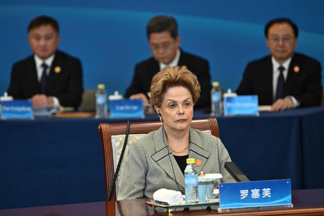 President of the New Development Bank (NDB) Dilma Rousseff attends the 1+10 Dialogue with leaders of International Economic Organisations, with China’s Premier Li Qiang (not pictured) in Beijing on December 9, 2025. (Photo by Pedro PARDO and Pedro Pardo / POOL / AFP)