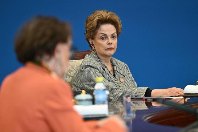 President of the New Development Bank (NDB) Dilma Rousseff attends the 1+10 Dialogue with leaders of International Economic Organisations, with China’s Premier Li Qiang (not pictured) in Beijing on December 9, 2025. (Photo by Pedro PARDO and Pedro Pardo / POOL / AFP)