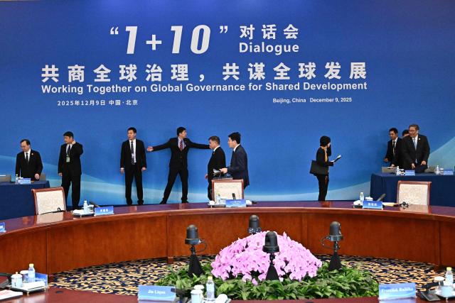 Delegates arrive for the 1+10 Dialogue with leaders of International Economic Organisations, with China’s Premier Li Qiang in Beijing on December 9, 2025. (Photo by Pedro PARDO and Pedro Pardo / POOL / AFP)