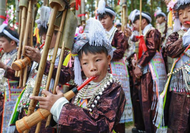 Members of the Miao ethnic group take part in a traditional sun-worshiping ceremony during the annual Lusheng Festival at the Basha Miao Village in Cangjiang County, in China's southwestern Guizhou province on December 8, 2025. (Photo by AFP) / China OUT