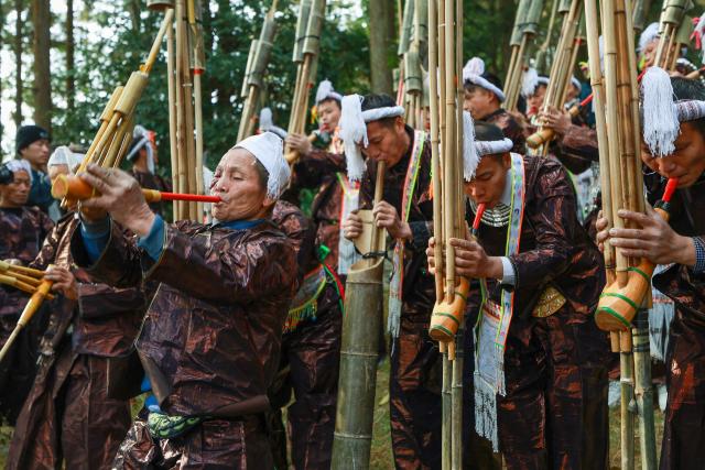 Members of the Miao ethnic group take part in a traditional sun-worshiping ceremony during the annual Lusheng Festival at the Basha Miao Village in Cangjiang County, in China's southwestern Guizhou province on December 8, 2025. (Photo by AFP) / China OUT