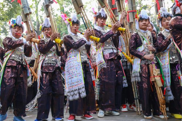 Members of the Miao ethnic group take part in a traditional sun-worshiping ceremony during the annual Lusheng Festival at the Basha Miao Village in Cangjiang County, in China's southwestern Guizhou province on December 8, 2025. (Photo by AFP) / China OUT