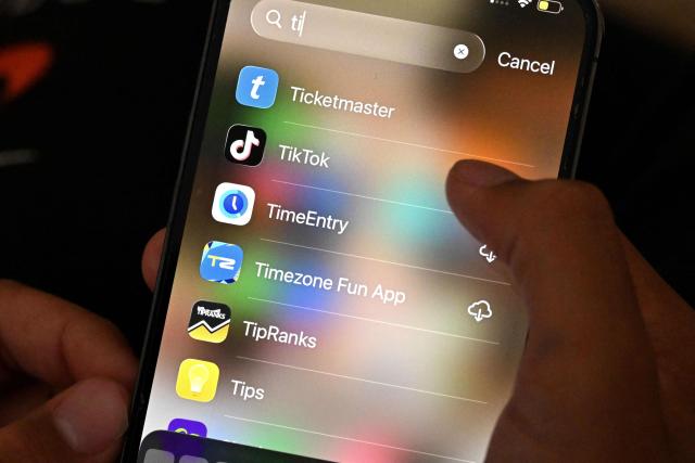 A 13-year-old boy poses at his home as he looks at social media on his mobile phone in Sydney on December 8, 2025. Australia will ban young teenagers from social media on December 10, 2025, launching a world-first crackdown designed to unglue children from addictive scrolling on the likes of Facebook, Instagram and TikTok. (Photo by Saeed KHAN / AFP)