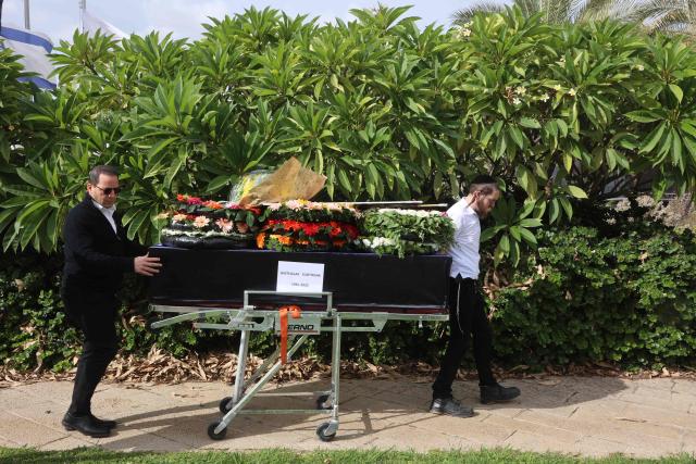 A member of a repatriation company prepare the coffin of a Thai national Sudthisak Rinthalak, who was kidnapped by Hamas militants from orchards near Kibbutz Be’eri on October 7, 2023, during a ceremony after his body was returned to Israel at Ben-Gurion Airport on December 9, 2025. (Photo by GIL COHEN-MAGEN / AFP)