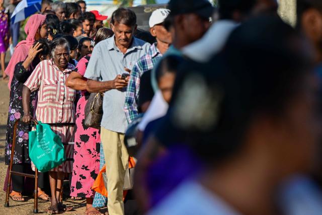 Flood victims arrive at a Japan Disaster Relief (JDR) medical camp in Chilaw on December 9, 2025. (Photo by Ishara S. KODIKARA / AFP)