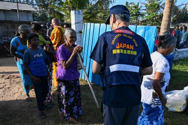Flood victims arrive at a Japan Disaster Relief (JDR) medical camp in Chilaw on December 9, 2025. (Photo by Ishara S. KODIKARA / AFP)