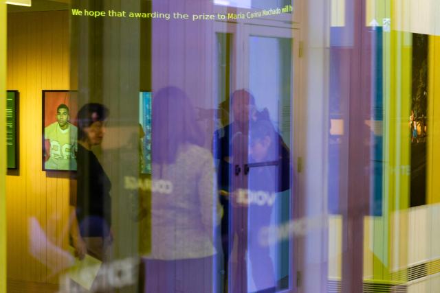 Visitors attend the exhibition "Democracy on the brink" in honour of Nobel Peace Prize laureate Maria Corina Machado at the Nobel Peace Center in Oslo on December 9, 2025, on the eve of the Nobel Peace Prize ceremony. The new exhibition featuring the 2025 laureate opens to the public on December 12, 2024. (Photo by Odd ANDERSEN / AFP)