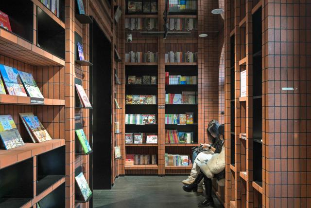 People visit a bookstore in Tianjin on December 9, 2025. (Photo by ADEK BERRY / AFP)