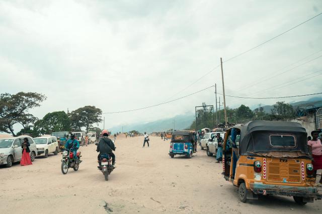 Commuters and pedestrians are seen along a road in Uvira on December 9, 2025. Intense fighting is taking place on Tuesday in the eastern Democratic Republic of Congo (DRC), with the M23 group, supported by the Rwandan army, continuing its rapid advance towards Uvira, a strategic Congolese city located near the border with neighboring Burundi and now under threat. The anti-government armed group and the Rwandan soldiers—estimated at 6,000 to 7,000 on Congolese soil according to UN experts—were reportedly only about fifteen kilometers north of the city, home to several hundred thousand inhabitants, as of Tuesday morning, according to security and military sources cited by AFP. (Photo by AFP)