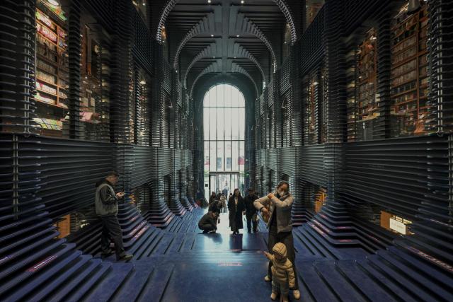 People visit a bookstore in Tianjin on December 9, 2025. (Photo by ADEK BERRY / AFP)