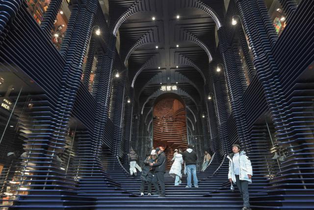 People visit a bookstore in Tianjin on December 9, 2025. (Photo by ADEK BERRY / AFP)