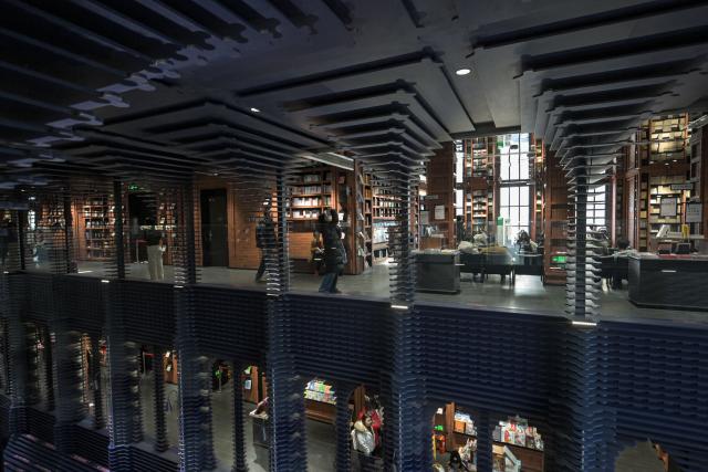 People visit a bookstore in Tianjin on December 9, 2025. (Photo by ADEK BERRY / AFP)