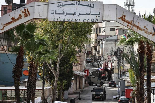 Israeli army soldiers take position during a military raid in Al-Amari refugee camp near the city of Ramallah in the Israeli-occupied West Bank on December 9, 2025. Violence in the West Bank, which Israel has occupied since 1967, has soared since the Hamas attack on Israel triggered the Gaza war in October 2023. At least 1,006 Palestinians, including militants, have been killed in the West Bank by Israeli forces or settlers since then, according to the Palestinian health ministry. During the same period, 43 Israelis, including soldiers, have been killed in Palestinian attacks in the West Bank, according to official Israeli figures. (Photo by Zain JAAFAR / AFP)