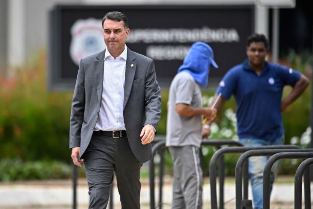 Senator Flavio Bolsonaro, son of former Brazilian president Jair Bolsonaro, leaves the Federal Police headquarters after visiting his father, in Brasilia, on December 09, 2025. (Photo by Ton MOLINA / AFP)