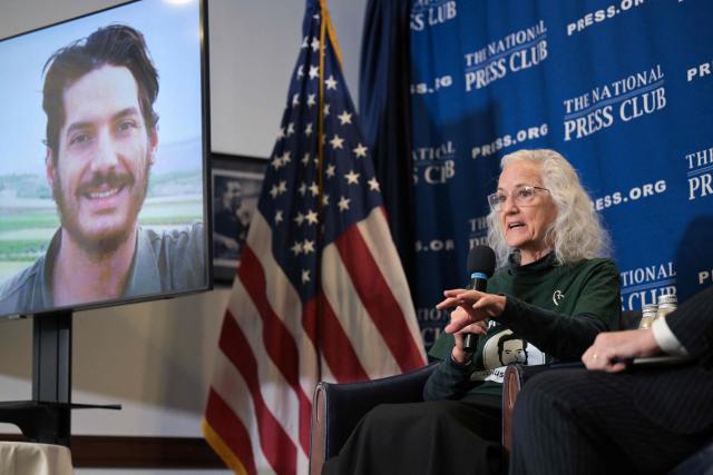 Debra Tice, mother of missing US journalist Austin Tice (displayed on screen), speaks during an event at the National Press Club "to address his case one year after the fall of Damascus" on December 9, 2025 in Washington, DC. Tice was kidnapped while reporting in Syria in August 2012. (Photo by Oliver Contreras / AFP)