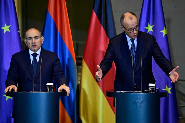 German Chancellor Friedrich Merz (R) and Armenia's Prime Minister Nikol Pashinyan address a joint press conference at the Chancellery in Berlin, Germany, on December 9, 2025. (Photo by John MACDOUGALL / AFP)