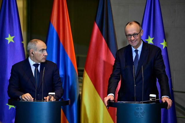 Armenia's Prime Minister Nikol Pashinyan (L) and German Chancellor Friedrich Merz address a joint press conference at the Chancellery in Berlin, Germany, on December 9, 2025. (Photo by John MACDOUGALL / AFP)
