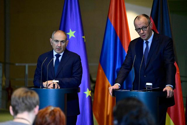 Armenia's Prime Minister Nikol Pashinyan (L) and German Chancellor Friedrich Merz address a joint press conference at the Chancellery in Berlin, Germany, on December 9, 2025. (Photo by John MACDOUGALL / AFP)