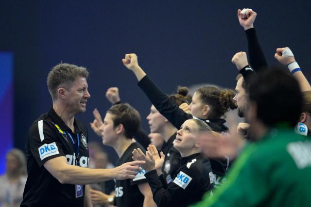 Germany's coach Markus Gaugisch (L) celebrates with the team during the quarter final match between Germany and Brazil of the IHF Women's Handball World Championship in Dortmund, western Germany on December 9, 2025. (Photo by Sascha Schuermann / AFP)