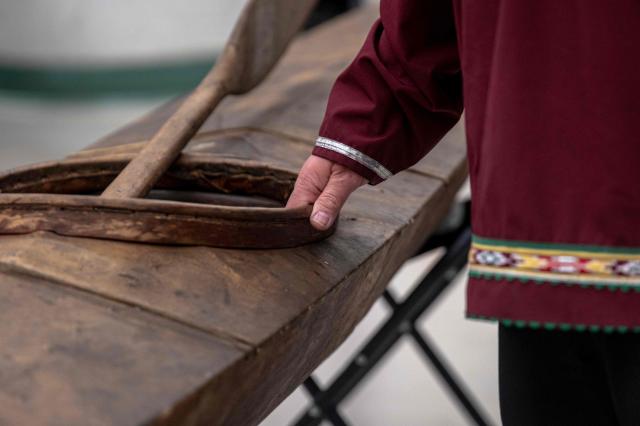 Darrel Nasogaluak, Elder and Chair of Tuktoyaktuk Community Corp., explains the craftsmanship behind the traditional Inuvialuit kayak during the unveiling of the indigenous artifacts at the Canadian Museum of History in Gatineau, Quebec, Canada, on December 9, 2025. The artifacts were returned to Montreal on Saturday December 6, 2025, after having been at the Vatican Museum for nearly a century. It took almost 20 years, including indigenous communities visiting the Vatican and meeting Pope Francis in 2022, to have the items returned. (Photo by ANDREJ IVANOV / AFP)