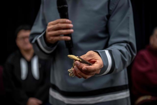 Natan Obed, president of the Inuit Tapiriit Kanatami (ITK), shows a harpoon tip during the unveiling of the indigenous artifacts at the Canadian Museum of History in Gatineau, Quebec, Canada, on December 9, 2025. The artifacts were returned to Montreal on Saturday December 6, 2025, after having been at the Vatican Museum for nearly a century. It took almost 20 years, including indigenous communities visiting the Vatican and meeting Pope Francis in 2022, to have the items returned. (Photo by ANDREJ IVANOV / AFP)