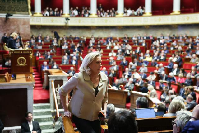 President of Rassemblement National parliamentary group Marine Le Pen walks after a vote on the Social Security financing bill for 2026 (PLFSS) at the National Assembly, France's lower house parliament, in Paris on December 9, 2025. (Photo by ALAIN JOCARD / AFP)