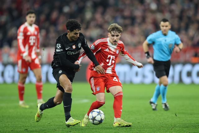 Sporting Lisbon's Portuguese midfielder #52 Joao Simoes and Bayern Munich's German midfielder #42 Lennart Karl vie for the ball during the UEFA Champions League, league phase - day 6 football match between Bayern Munich and Sporting CP in Munich, southern Germany, on December 9, 2025. (Photo by Alexandra BEIER / AFP)
