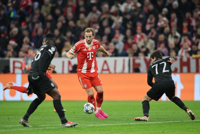 Bayern Munich's English forward #09 Harry Kane vies for the ball with Sporting Lisbon's Ivorian defender #26 Ousmane Diomande and Sporting Lisbon's Portuguese defender #72 Eduardo Quaresma during the UEFA Champions League, league phase - day 6 football match between Bayern Munich and Sporting CP in Munich, southern Germany, on December 9, 2025. (Photo by Alexandra BEIER / AFP)