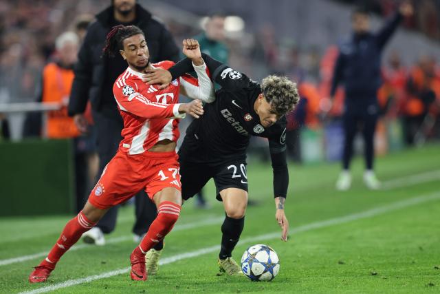 Bayern Munich's French midfielder #17 Michael Olise and Sporting Lisbon's Uruguayan midfielder #20 Maximiliano Araujo vie for the ball during the UEFA Champions League, league phase - day 6 football match between Bayern Munich and Sporting CP in Munich, southern Germany, on December 9, 2025. (Photo by Alexandra BEIER / AFP)