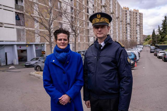 Prefect delegate to the police prefect of Bouches du Rhone, Corinne Simon (L) and Prefect of the Provence-Alpes-Cote d'Azur, Jacques Witkowski (R), pose for a photograph during a major anti-drug operation at "La Cites des Oliviers A" residential complex, in the Sainte Marthe neighborhood, northern Marseille, on December 9, 2025. A large-scale operation has been launched in the northern districts of Marseille with 1,500 police officers deployed to simultaneously target 15 drug dealing spots in order to take back the territory from drug traffickers. (Photo by Miguel MEDINA / AFP)
