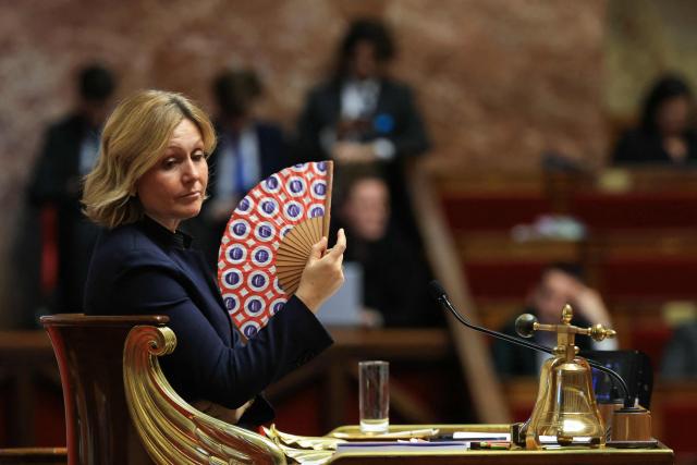 President of the French National Assembly Yael Braun-Pivet waves a National Assembly fan during the explanation of vote after the results of the vote on the third part of the Social Security financing bill for 2026 (PLFSS) at the National Assembly, France's lower house parliament, in Paris on December 9, 2025. (Photo by Alain JOCARD / AFP)