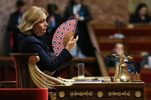 President of the French National Assembly Yael Braun-Pivet waves a National Assembly fan during the explanation of vote after the results of the vote on the third part of the Social Security financing bill for 2026 (PLFSS) at the National Assembly, France's lower house parliament, in Paris on December 9, 2025. (Photo by Alain JOCARD / AFP)