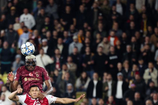 Galatasaray's Nigerian forward #45 Victor Osimhen (rear) heads the ball over Monaco's Brazilian defender #02 Vanderson (front) during the UEFA Champions League, league phase, football match between Monaco and Galatasaray, at the Stade Louis II stadium, in Monaco, on December 9, 2025. (Photo by Valery HACHE / AFP)