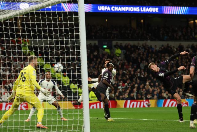 Slavia Prague's Czech defender #04 David Zima (R) heads the ball past his own keeper for an own-goal, Tottenham's first goal during the UEFA Champions League football league stage match between Tottenham Hotspur and Slavia Prague at the Tottenham Hotspur Stadium in London, on December 9, 2025. (Photo by Adrian Dennis / AFP)