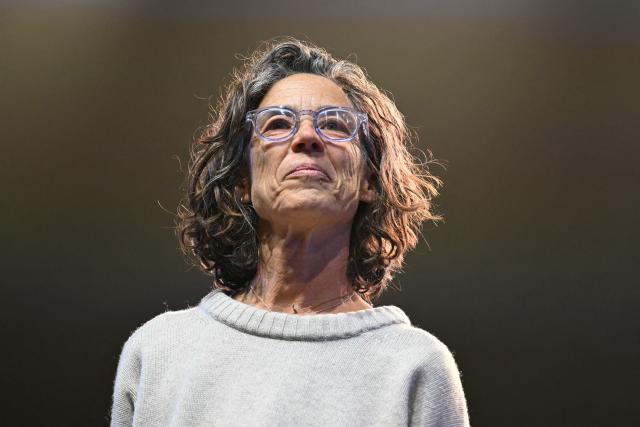 Head of medical activities for Doctors Without Borders (MSF - Medecins Sans Frontieres) Karin Huster speaks on stage during a "Together for Palestine" benefit concert at the Zenith Paris event venue, in Paris on December 9, 2025. (Photo by Anna KURTH / AFP)