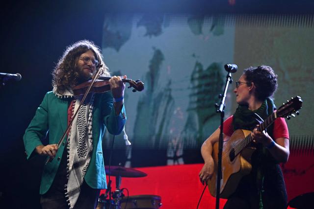 Elik Harpaz (L) and Ayelet Ben Ishay (R) perform on stage during a "Together for Palestine" benefit concert at the Zenith Paris event venue, in Paris on December 9, 2025. (Photo by Anna KURTH / AFP)